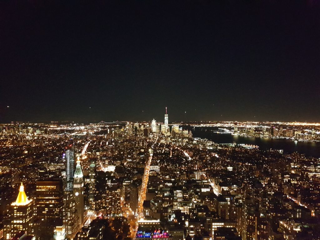 View from the Empire State Building at Night with planes landing