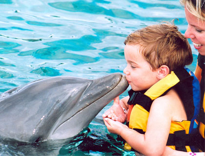 Swim with Dolphins Mayan Riviera and Fantasy Snorkel- Child Giving Dolphin A Kiss