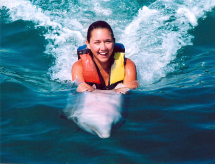 Swim with Dolphins Mayan Riviera and Fantasy Snorkel-  Woman Swimming On Dolphins Belly