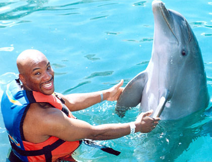 Swim with Dolphins Mayan Riviera and Fantasy Snorkel- Guy and Dolphin Join Hands And Fins